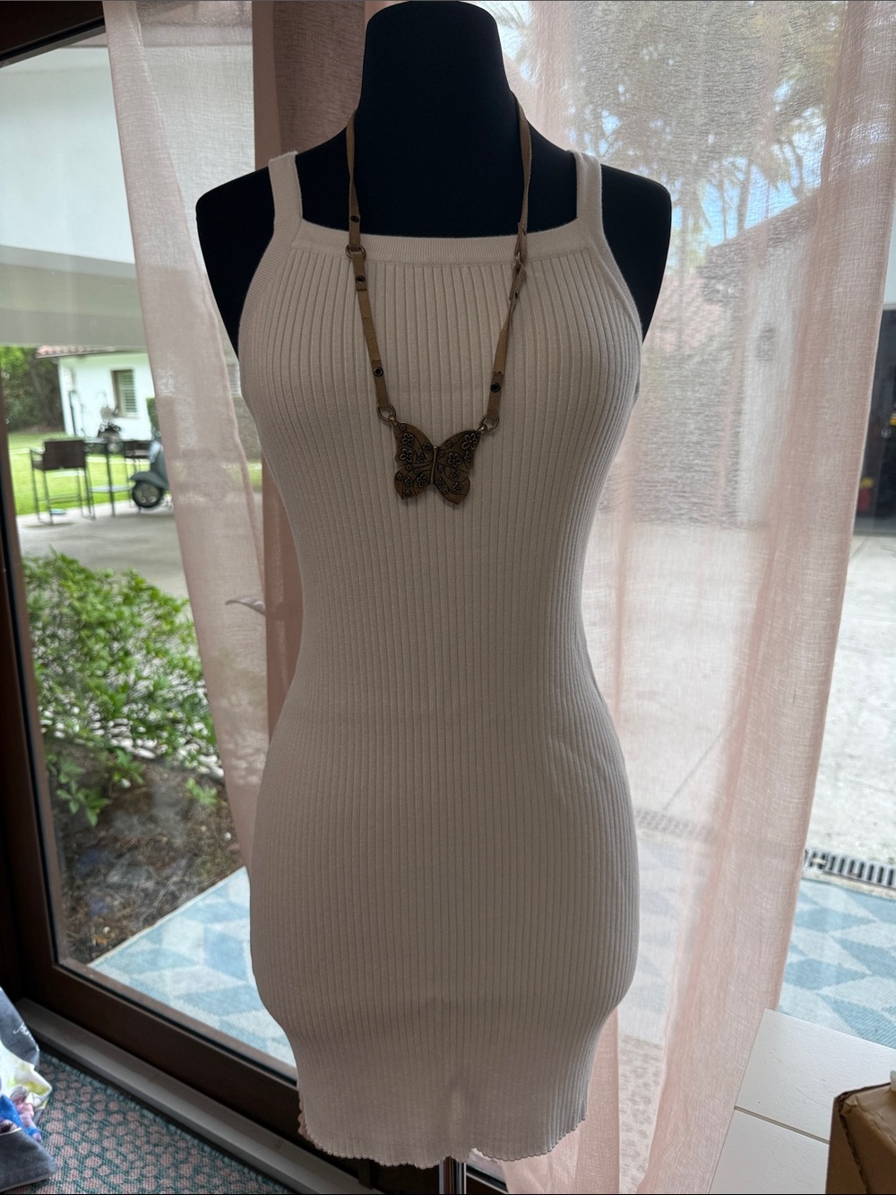 Sabo Skirt "Emine Dress" is a white ribbed knit garment designed in Australia
